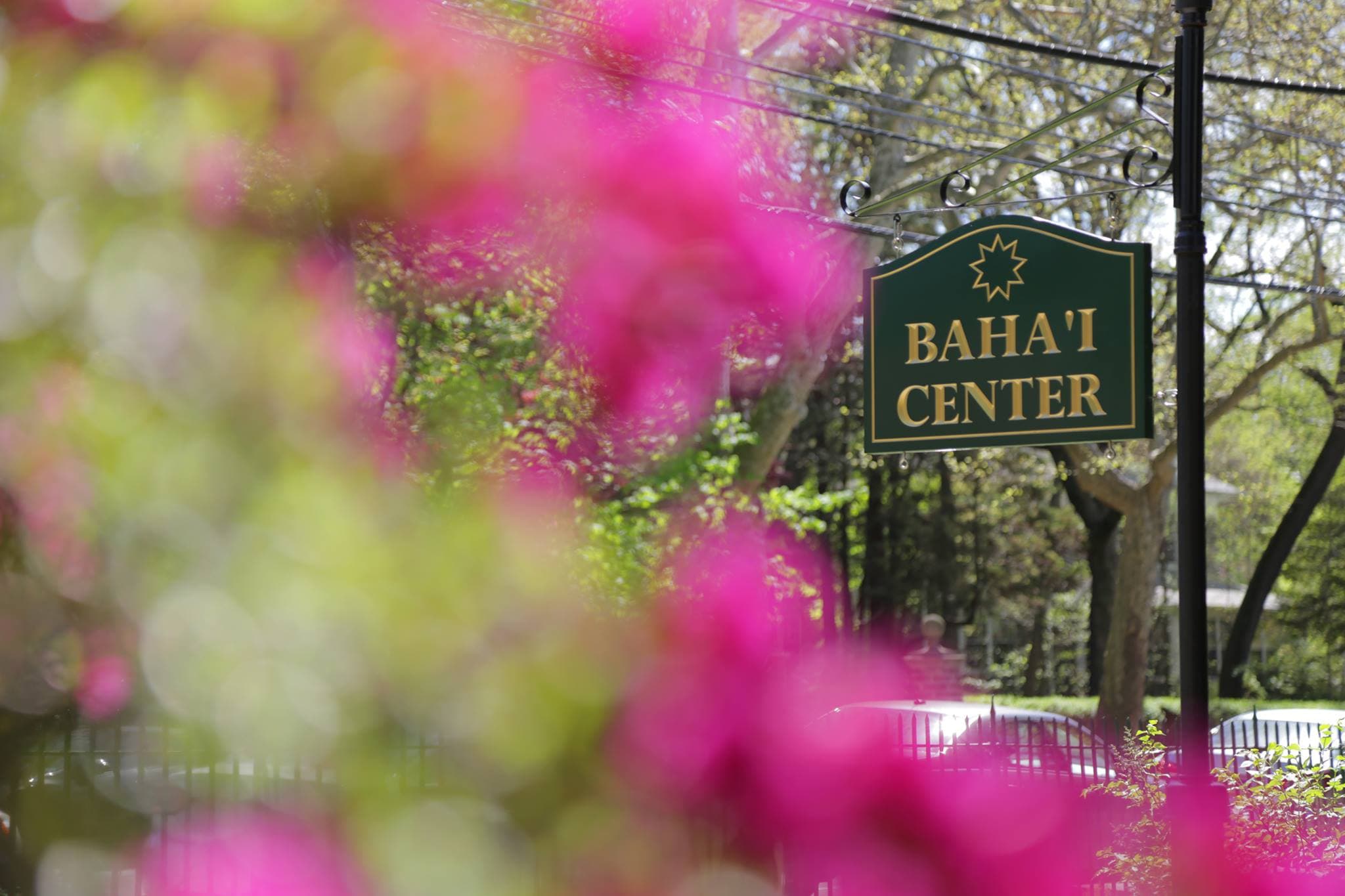 Bahá'í Center sign with pink flowers